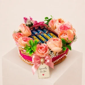 Luxury floral chocolate gift hamper basket with Perk chocolates, artificial pink roses, decorative ribbon, and handcrafted premium gift design by Kaushik Krafts.